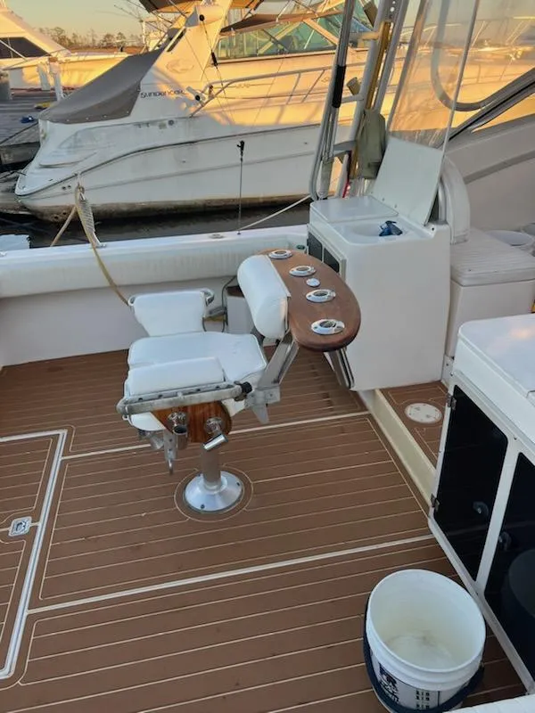 Slide: The Image of 1998 Albemarle 320 Express Fisherman boat deck with fishing chair and rod holders. - 16