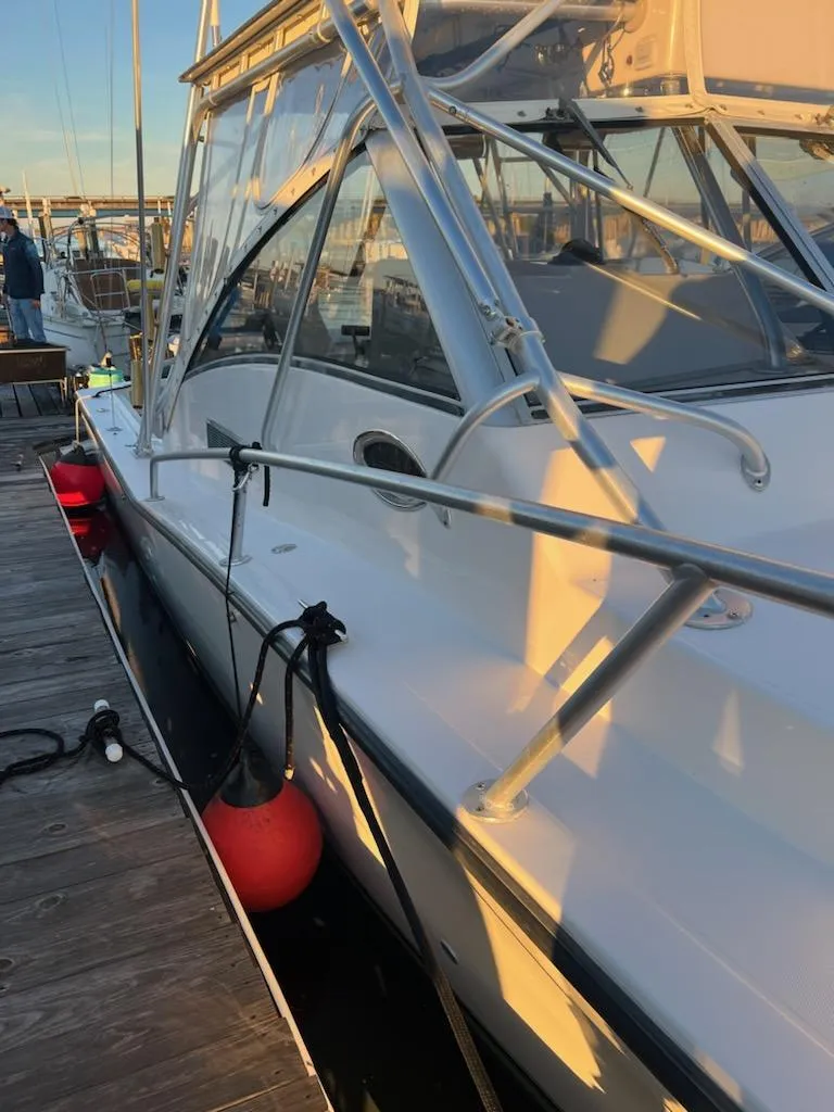 Slide: The Image of 1998 Albemarle 320 Express Fisherman docked with red fenders, side view. - 17