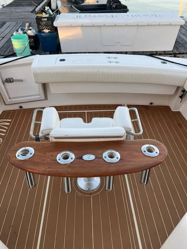 Slide: The Image of 1998 Albemarle 320 Express Fisherman boat deck with fishing chair and rod holders. - 25