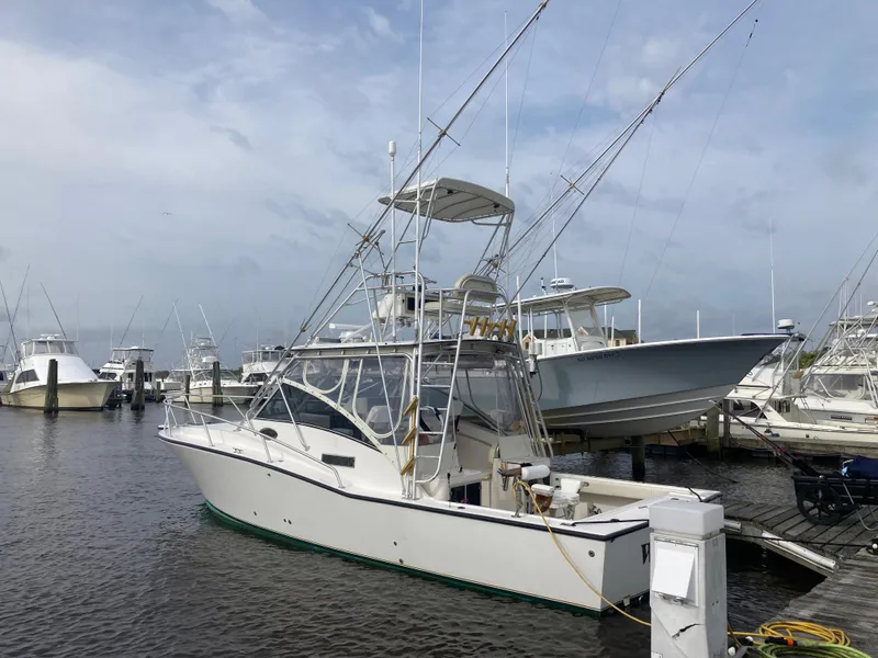 Slide: The Image of 1998 Albemarle 320 Express Fisherman boat docked at marina. - 3