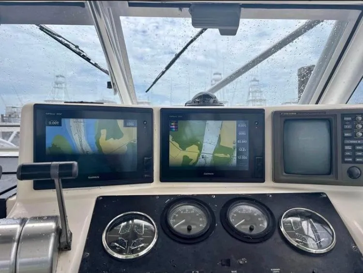 Slide: The Image of 1998 Albemarle 320 Express Fisherman dashboard with navigation screens and gauges. - 31