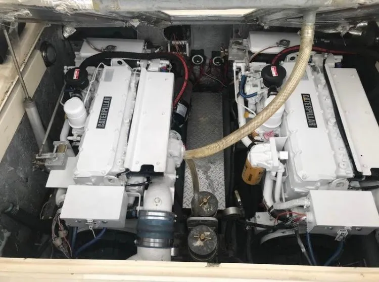 Slide: The Image of Engine compartment of 1998 Albemarle 320 Express Fisherman boat, featuring dual engines. - 34