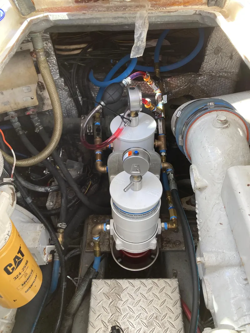 Slide: The Image of Engine compartment of a 1998 Albemarle 320 Express Fisherman boat, showing filters and hoses. - 35