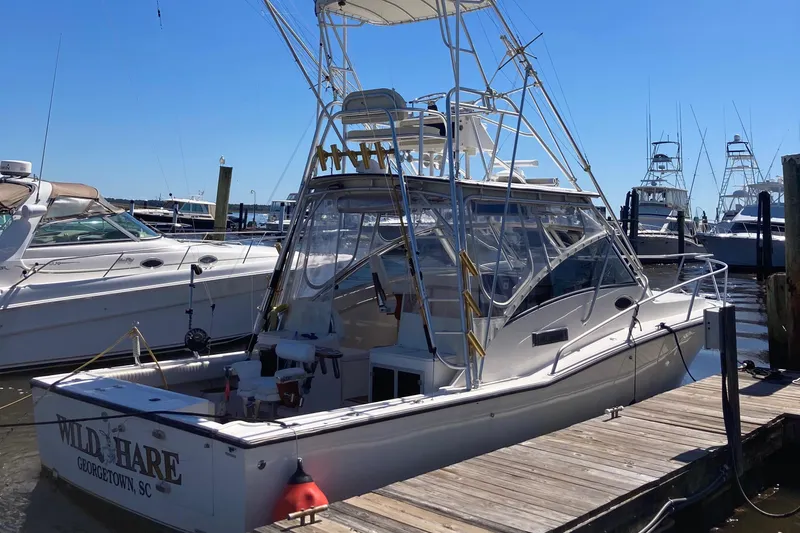 Slide: The Image of 1998 Albemarle 320 Express Fisherman docked at marina under clear blue sky. - 4