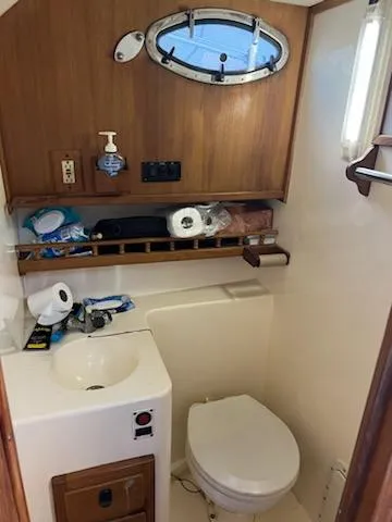 Slide: The Image of 1998 Albemarle 320 Express Fisherman boat bathroom with sink and toilet. - 41