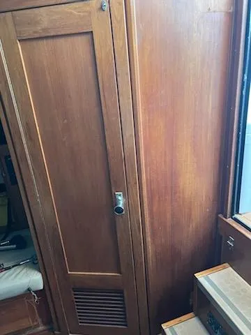 Slide: The Image of Wooden interior of 1998 Albemarle 320 Express Fisherman boat, featuring a cabinet and stairs. - 42