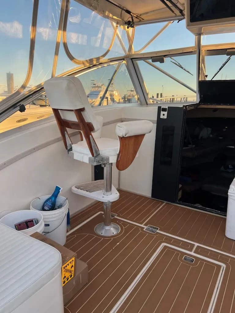 Slide: The Image of 1998 Albemarle 320 Express Fisherman boat interior with captain's chair and panoramic windows. - 46