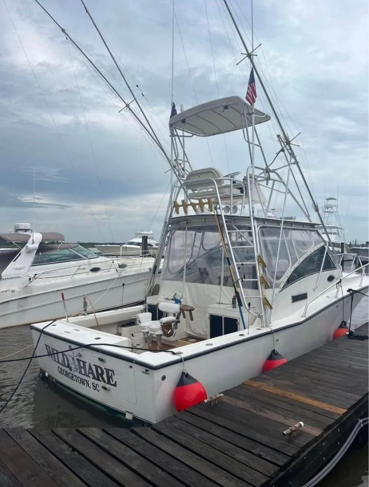 Slide: The Image of 1998 Albemarle 320 Express Fisherman boat docked at marina. - 5