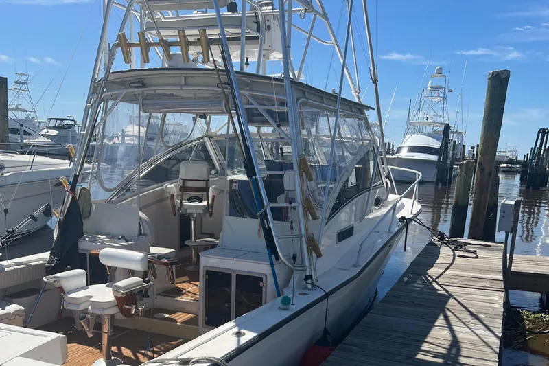 Slide: The Image of 1998 Albemarle 320 Express Fisherman docked at marina under clear blue sky. - 6