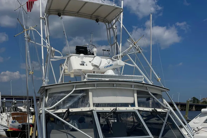 Slide: The Image of 1998 Albemarle 320 Express Fisherman boat docked under a clear blue sky. - 7