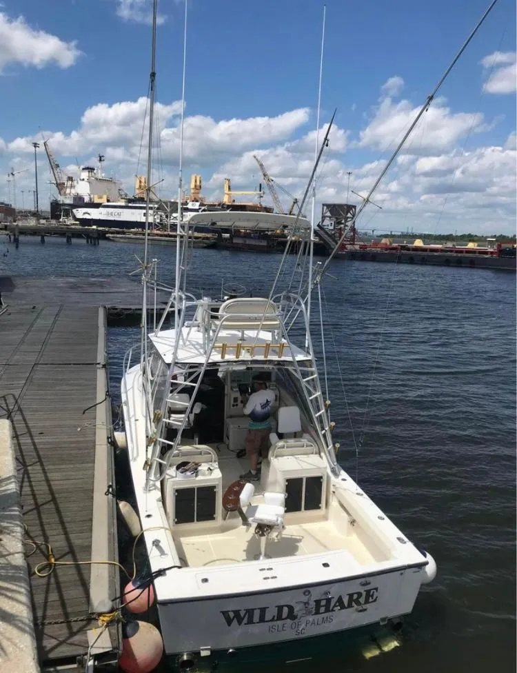 Slide: The Image of 1998 Albemarle 320 Express Fisherman docked at marina under blue sky. - 8