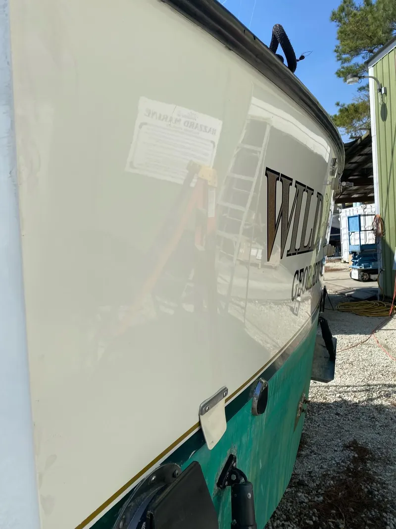 Slide: The Image of 1998 Albemarle 320 Express Fisherman boat side view in a yard setting. - 9