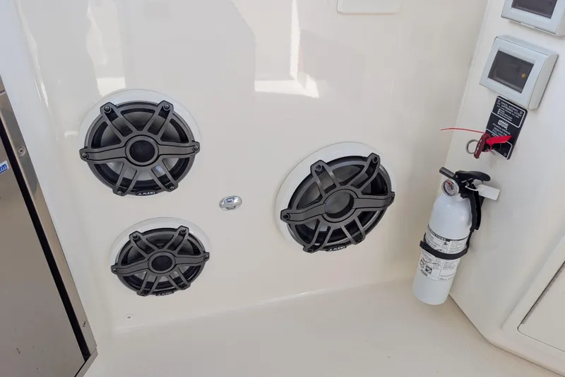Slide: The Image of 2024 Boston Whaler 350 Realm interior with speakers and fire extinguisher. - 12