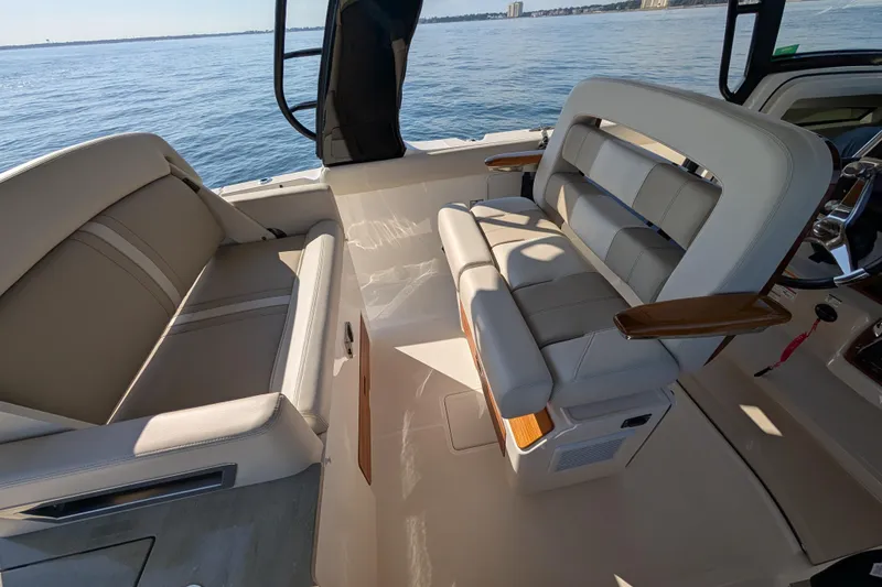 Slide: The Image of 2024 Boston Whaler 350 Realm interior with luxurious seating and ocean view. - 13