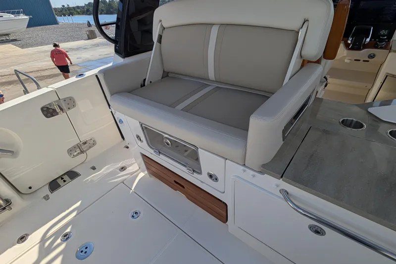 Slide: The Image of 2024 Boston Whaler 350 Realm interior with seating and storage features. - 18