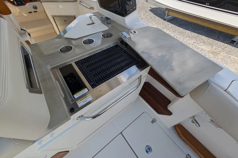 Slide: The Image of 2024 Boston Whaler 350 Realm boat kitchen with grill and countertop. - 19