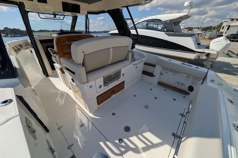 Slide: The Image of 2024 Boston Whaler 350 Realm boat interior with seating and deck view. - 22