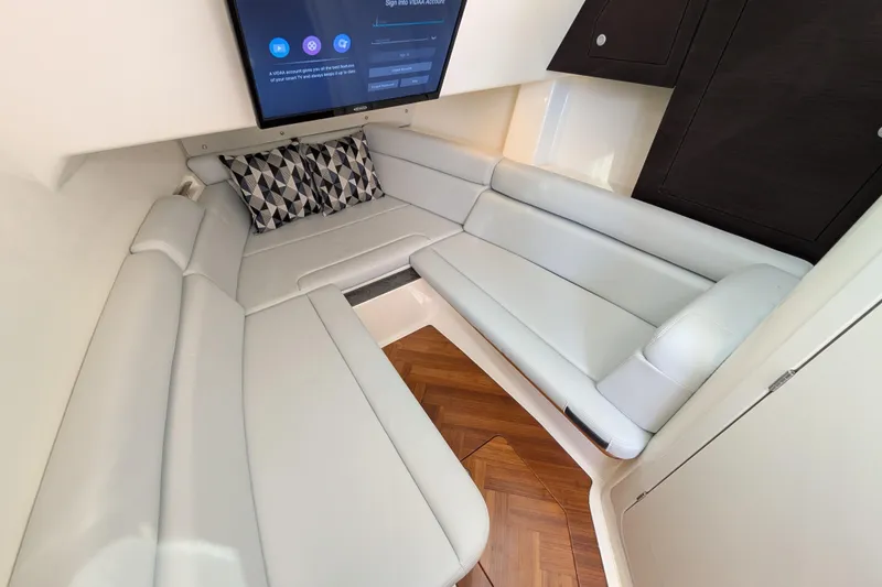 Slide: The Image of 2024 Boston Whaler 350 Realm interior with plush seating and modern design. - 25