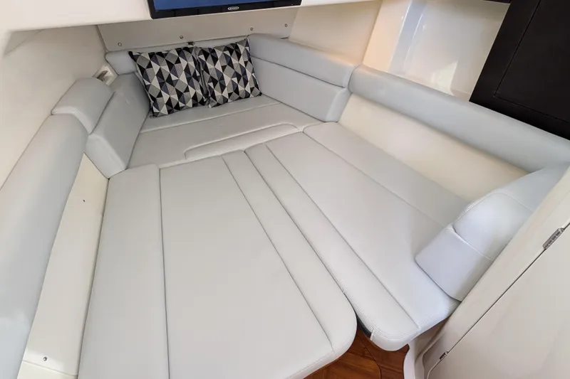 Slide: The Image of Luxurious interior cabin of 2024 Boston Whaler 350 Realm with plush seating and geometric pillows. - 26