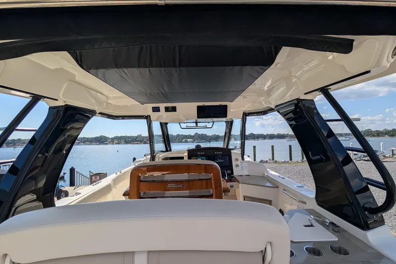 Slide: The Image of Interior view of 2024 Boston Whaler 350 Realm boat, overlooking serene waterfront. - 30