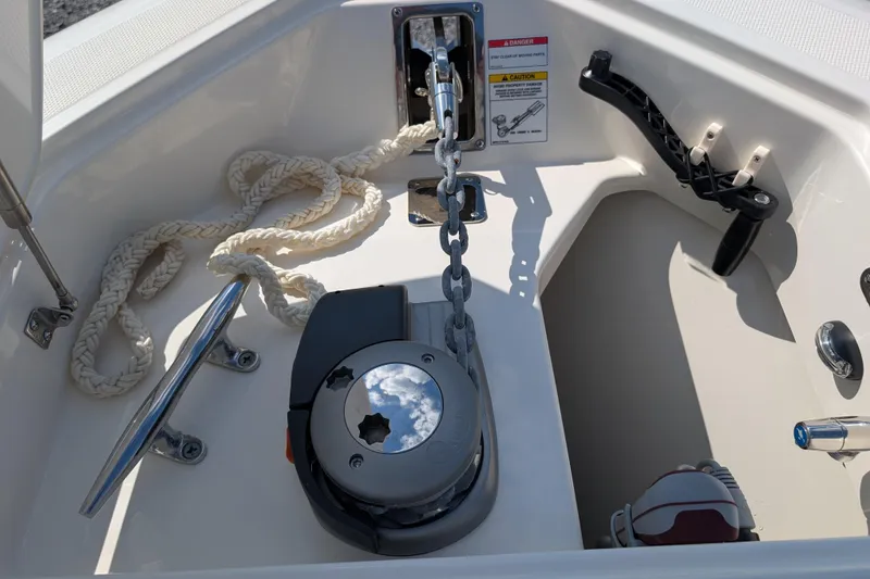 Slide: The Image of 2024 Boston Whaler 350 Realm anchor system with chain and rope in boat compartment. - 31