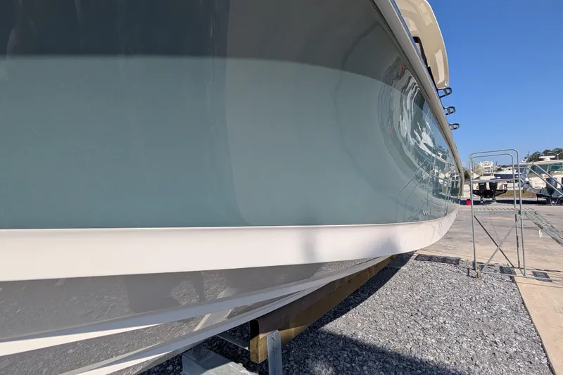Slide: The Image of 2024 Boston Whaler 350 Realm boat hull in a marina setting. - 41
