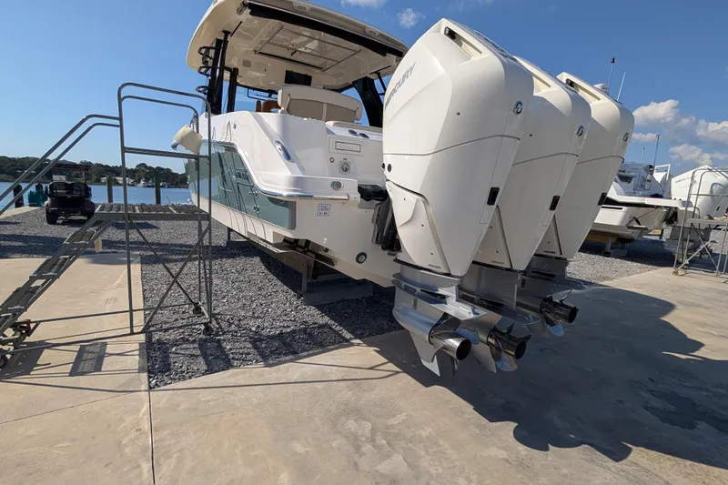 Slide: The Image of 2024 Boston Whaler 350 Realm with triple outboard engines on display. - 49