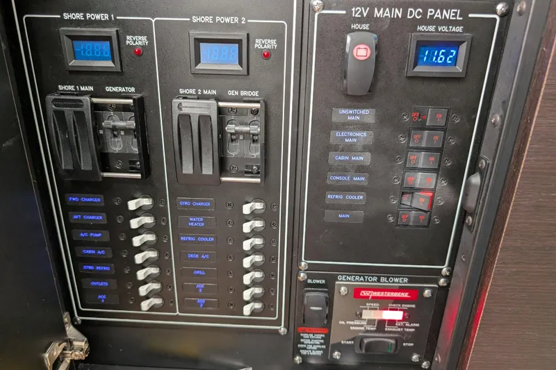 Slide: The Image of Electrical control panel of 2024 Boston Whaler 350 Realm boat, featuring switches and voltage display. - 52