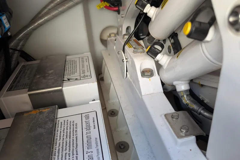 Slide: The Image of Engine compartment of 2024 Boston Whaler 350 Realm, showcasing mechanical components and wiring. - 56