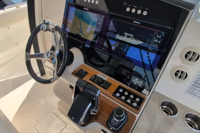 Slide: The Image of 2024 Boston Whaler 350 Realm helm with advanced navigation displays and controls. - 6