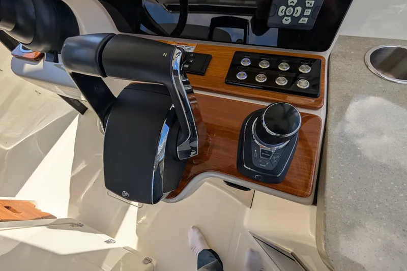 Slide: The Image of 2024 Boston Whaler 350 Realm helm controls with modern dashboard and joystick. - 7