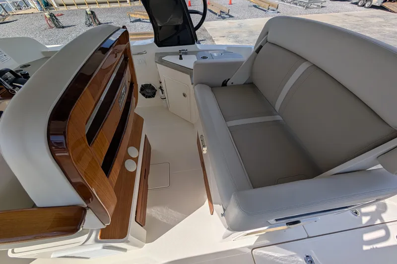 Slide: The Image of 2024 Boston Whaler 350 Realm interior with luxurious seating and wood accents. - 8