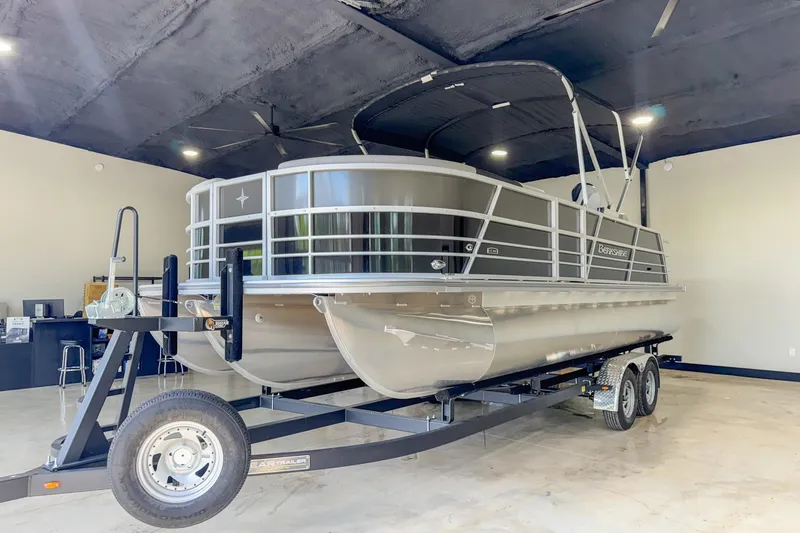 Slide: The Image of 2024 Berkshire 24UL LE B pontoon boat on trailer in showroom. - 12