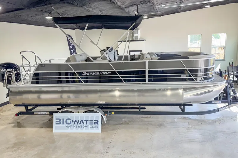 Slide: The Image of 2024 Berkshire 24UL LE B pontoon boat displayed indoors at Big Water Marine. - 5