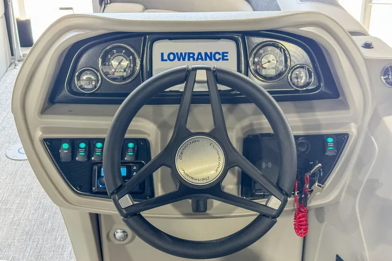 Slide: The Image of 2024 Berkshire 24UL LE B boat dashboard with steering wheel and Lowrance display. - 7