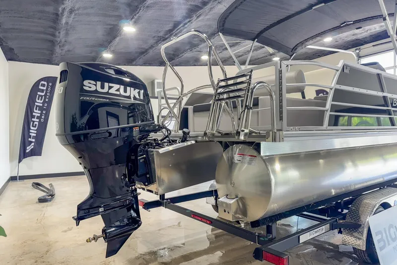 Slide: The Image of 2024 Berkshire 24UL LE B pontoon boat with Suzuki outboard motor in showroom. - 8