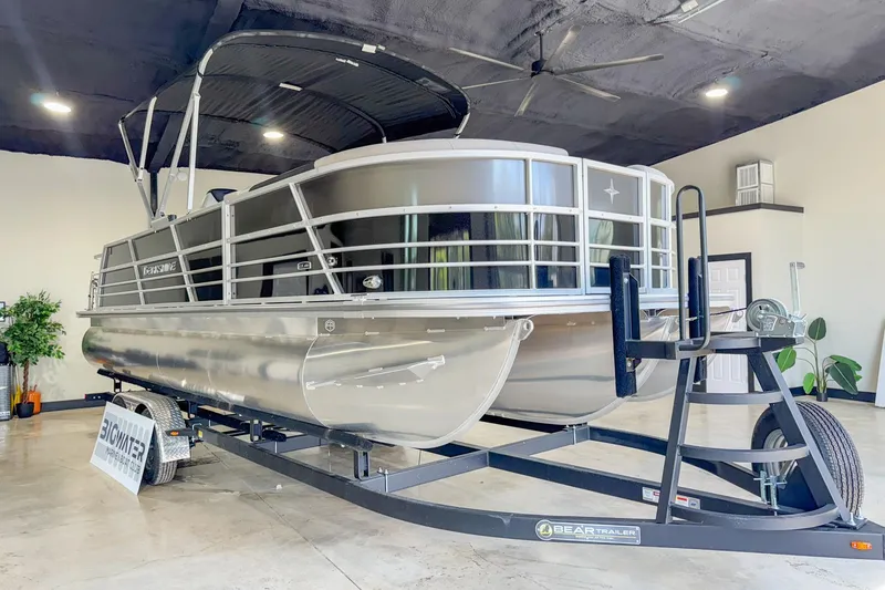 Slide: The Image of 2024 Berkshire 24UL LE B pontoon boat on trailer in showroom. - 9