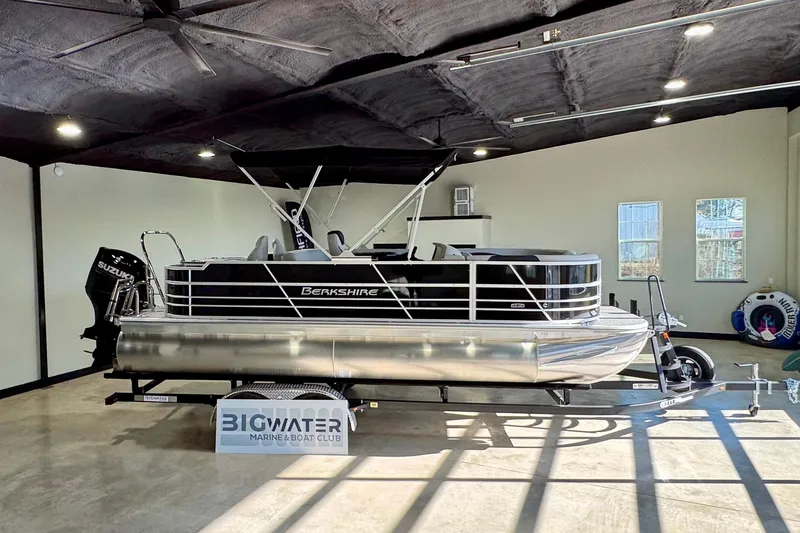 Slide: The Image of 2025 Berkshire 24RFC LE boat interior with modern seating and control console. - 10