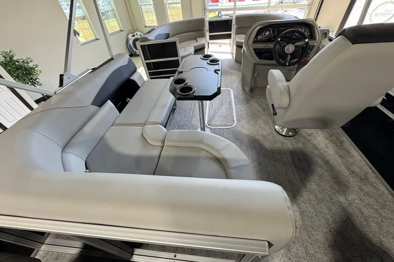 Slide: The Image of Interior of 2025 Berkshire 24RFC LE pontoon boat with plush seating and modern helm. - 13