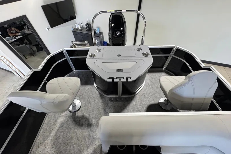 Slide: The Image of 2025 Berkshire 24RFC LE pontoon boat with Suzuki engine in a spacious showroom. - 2