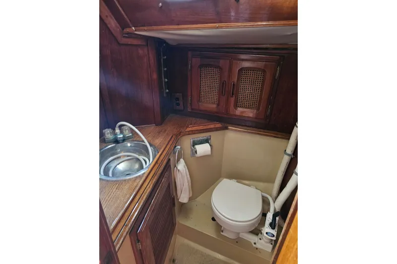 Slide: The Image of 1978 Islander 36 yacht bathroom with wooden cabinets and compact sink. - 14