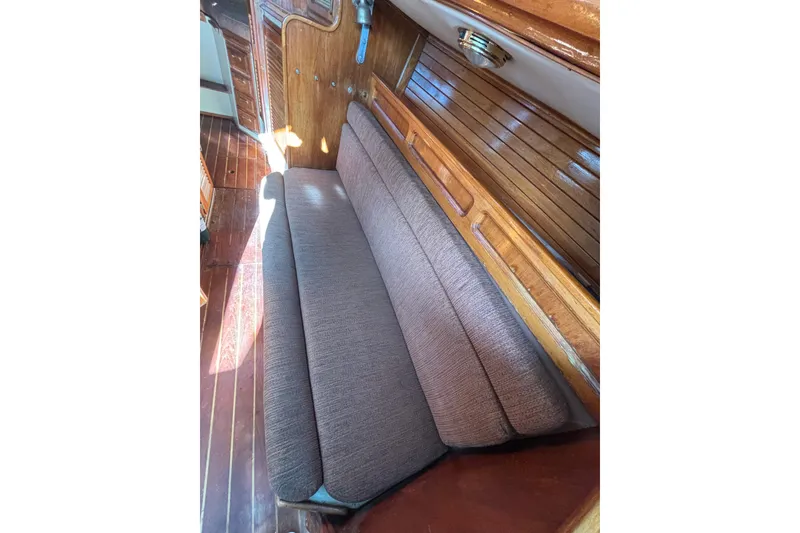 Slide: The Image of 1978 Islander 36 interior with wooden paneling and cushioned seating. - 17