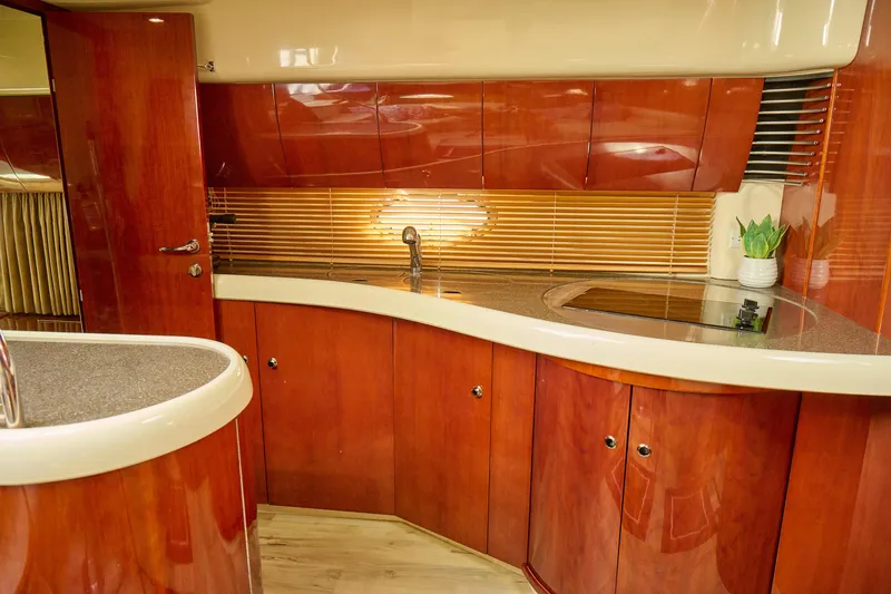 Slide: The Image of Luxurious 2001 Fairline 43 yacht kitchen with sleek wood cabinetry and modern fixtures. - 16