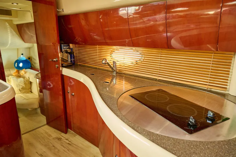 Slide: The Image of Luxurious 2001 Fairline 43 yacht interior with modern kitchen and cozy seating area. - 17