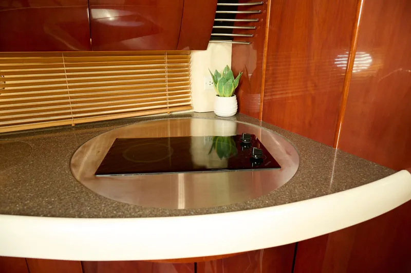 Slide: The Image of Luxurious Fairline 43 yacht kitchen with sleek cooktop and elegant wood finish, 2001 model. - 18