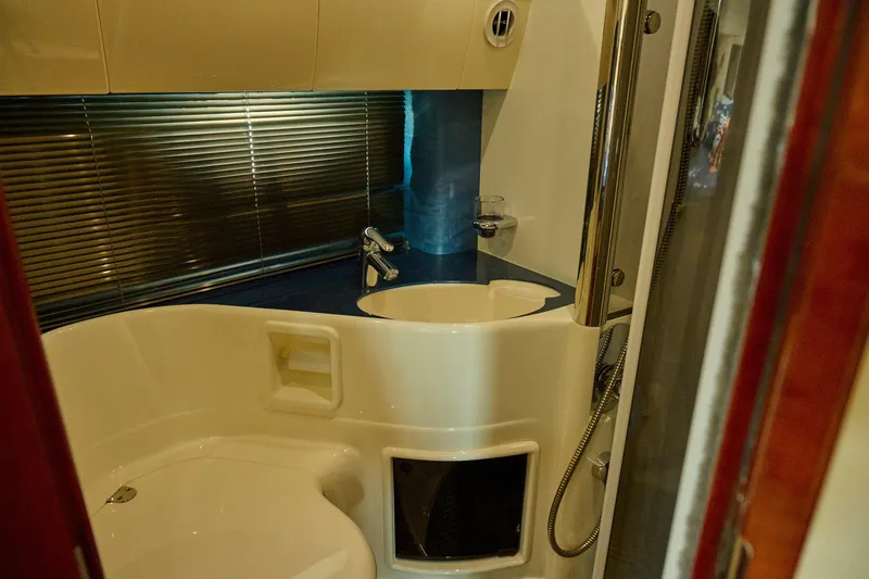 Slide: The Image of Bathroom interior of a 2001 Fairline 43 yacht, featuring modern fixtures and sleek design. - 20