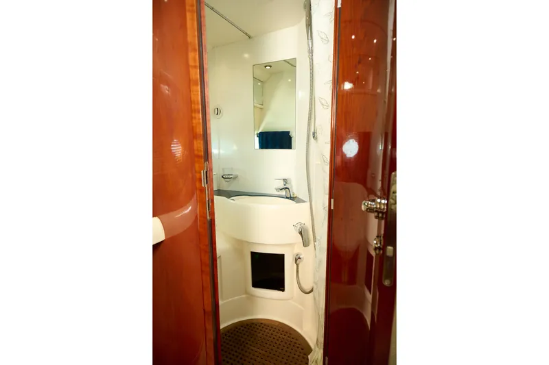 Slide: The Image of Bathroom interior of 2001 Fairline 43 yacht, featuring a compact sink and shower area. - 22