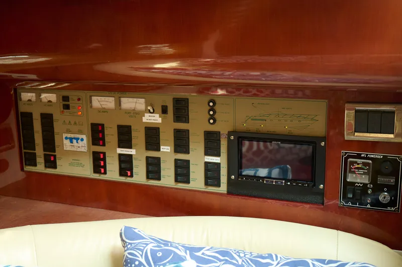 Slide: The Image of Control panel of a 2001 Fairline 43 yacht, featuring various switches and gauges. - 25