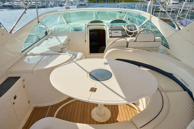 Slide: The Image of Luxurious 2001 Fairline 43 yacht interior with elegant seating and helm, docked at marina. - 30