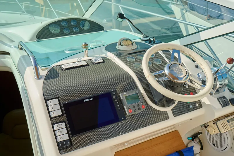 Slide: The Image of Cockpit of 2001 Fairline 43 yacht with steering wheel and navigation controls. - 33